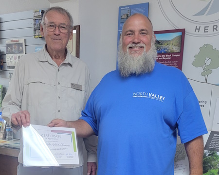 Bob presenting Dustin of North Valley Junk Removal certificate 

